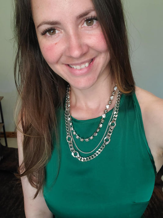 Selfie with a 3 strand silver necklace and green dress 