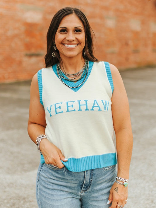 Woman wearing a sleeveless sweater with 'YEEHAW' text
