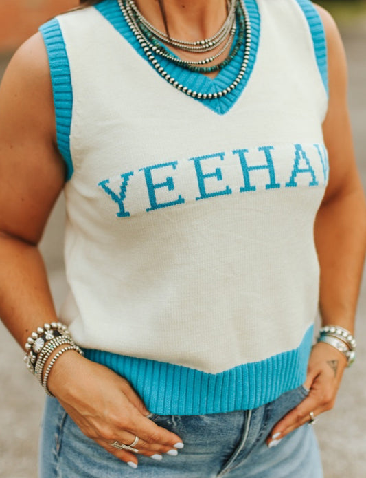 Person wearing a sleeveless sweater with 'YEEHAW' text in blue on a white background.
